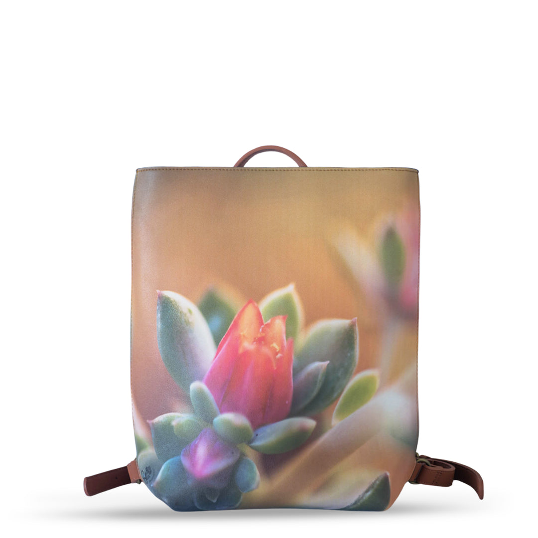 Stylish Echeveria Faux Leather Backpack featuring a vibrant floral design, perfect for any fashion-forward look.