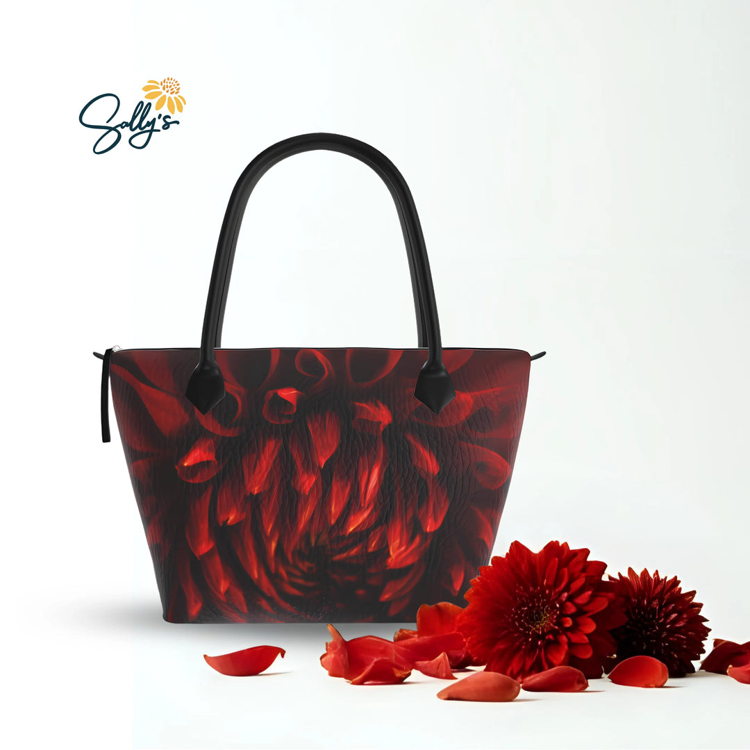 Crimson Dahlia Zip Top Bag on a whiteish background with a bit of green and red flowers off to the left side of the bag
