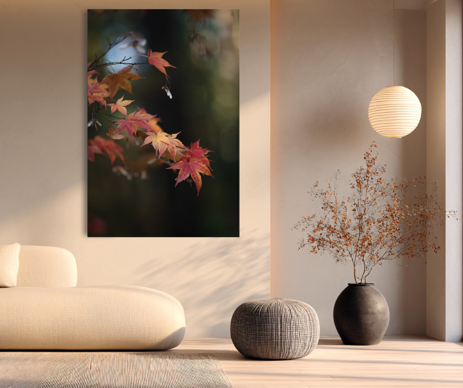 Modern living room with a photograph of autumn leaves, a lamp, and decorative vases.