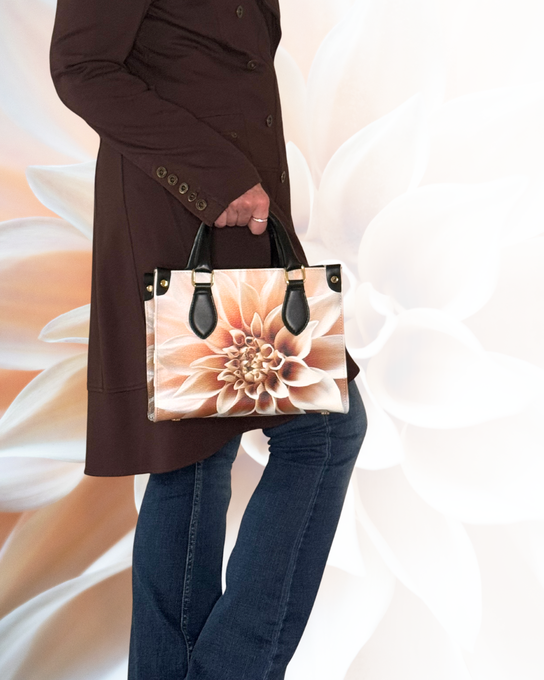 Person carrying a structured tote printed with a large peach and cream dahlia.