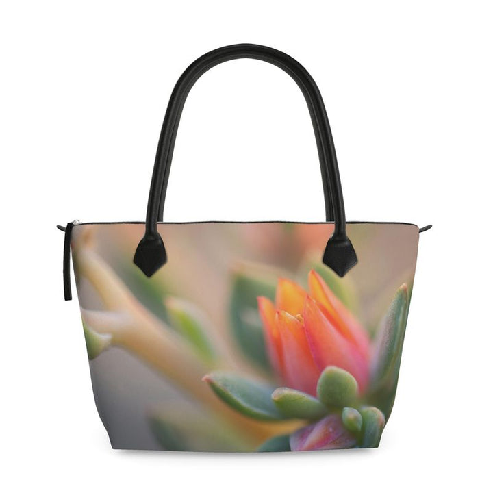 Structured zip top handbag featuring echeveria succulent artwork, leather handles, interior pockets, and 17-inch laptop capacity. Canvas Weave
