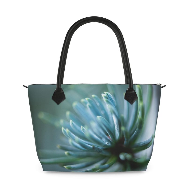 Structured zip top handbag featuring Spring Rain botanical artwork, leather handles, interior pockets, and 17-inch laptop capacity. Canvas Weave
