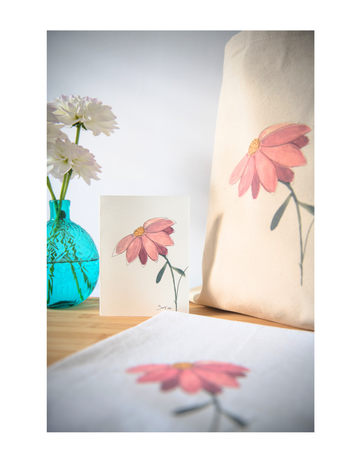 Canvas tote bag displaying the original watercolor painting In Her Own Way styled with coordinating botanical home décor.