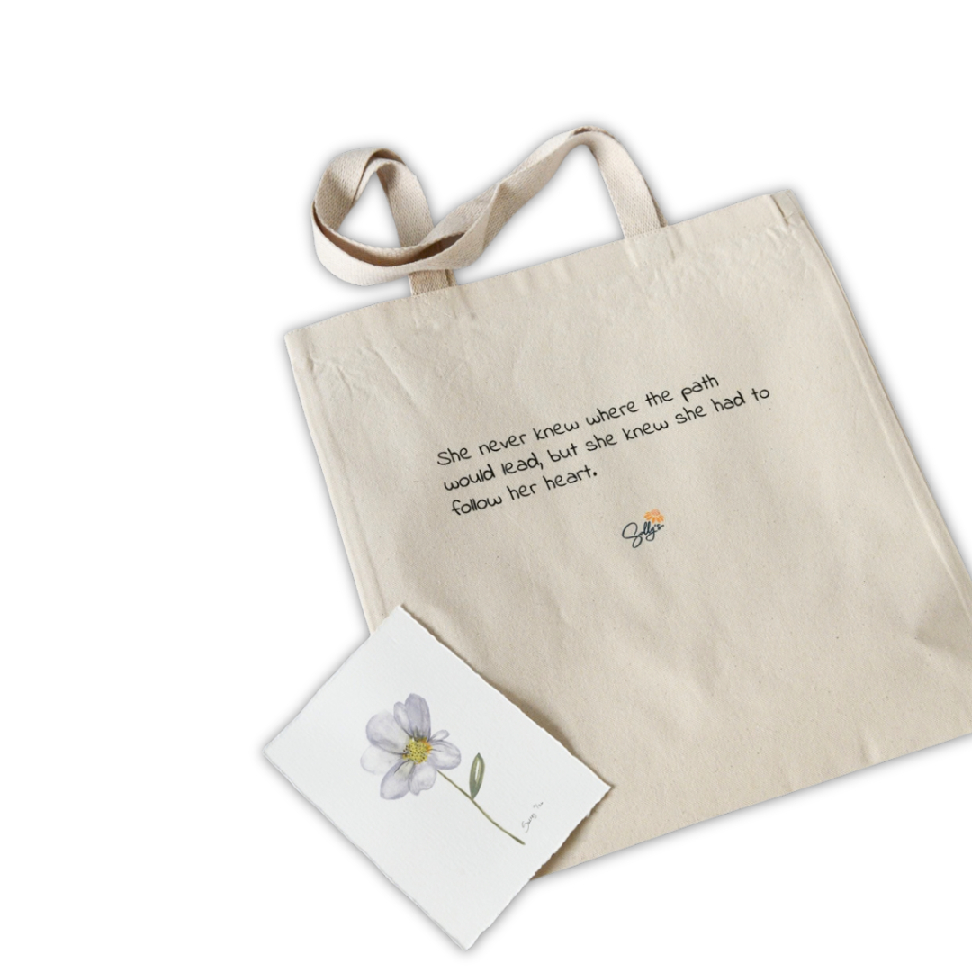 Back of She Had Other Plans natural canvas tote featuring an inspirational message and Sally Halvorsen’s original watercolor flower artwork.