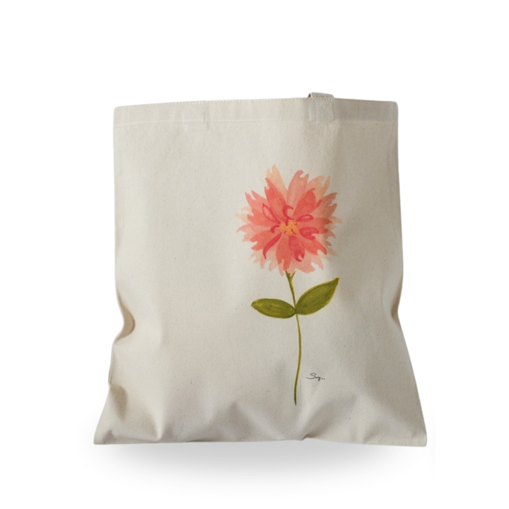 A Little Bit Sassy natural canvas tote featuring Sally Halvorsen’s original watercolor of a coral flower with layered petals, a slender green stem, and two leaves.