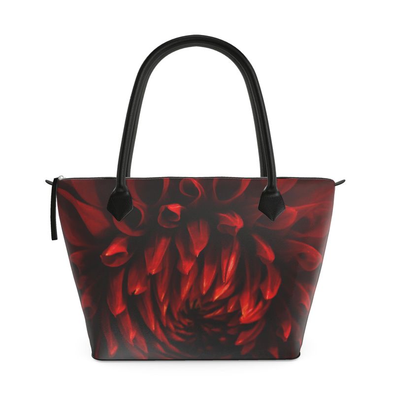 Crimson dahlia zip top handbag with rich red swirling petals on a dark background, structured silhouette with black leather handles and top zipper closure, botanical art design by Sally Halvorsen. Smooth Nappa Leather