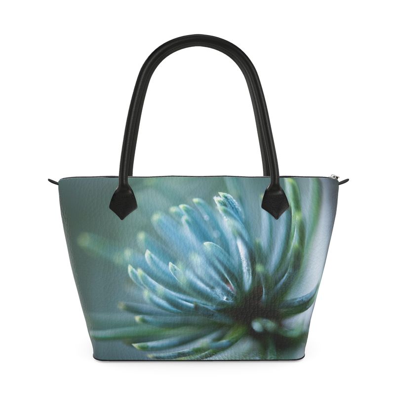 Structured zip top handbag featuring Spring Rain botanical artwork, leather handles, interior pockets, and 17-inch laptop capacity. Textured Nappa
