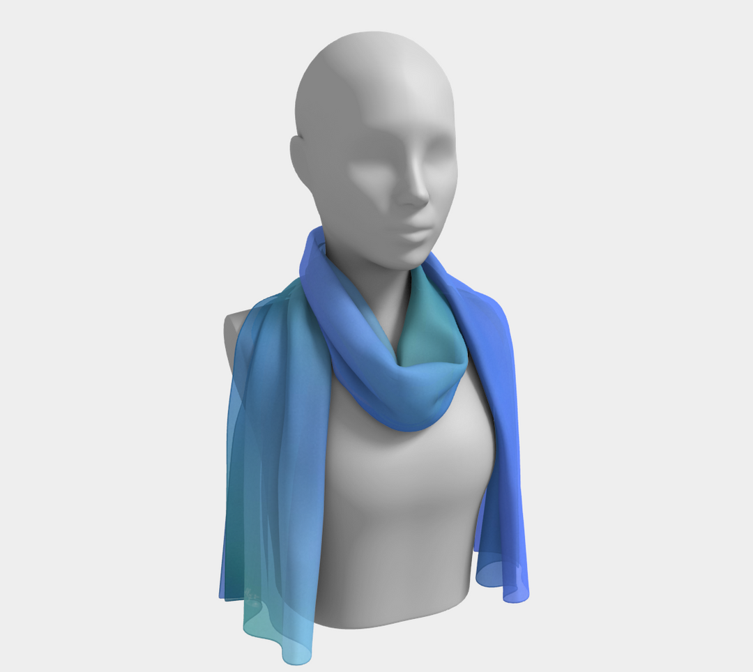 This simple long silk scarf reminds me of the ocean.  Calming colors of light to medium blue with a soft aqua green, no pattern on this scarf.  This scarf is perfect for summer  us it to tie your hair back or wear it around your neck.