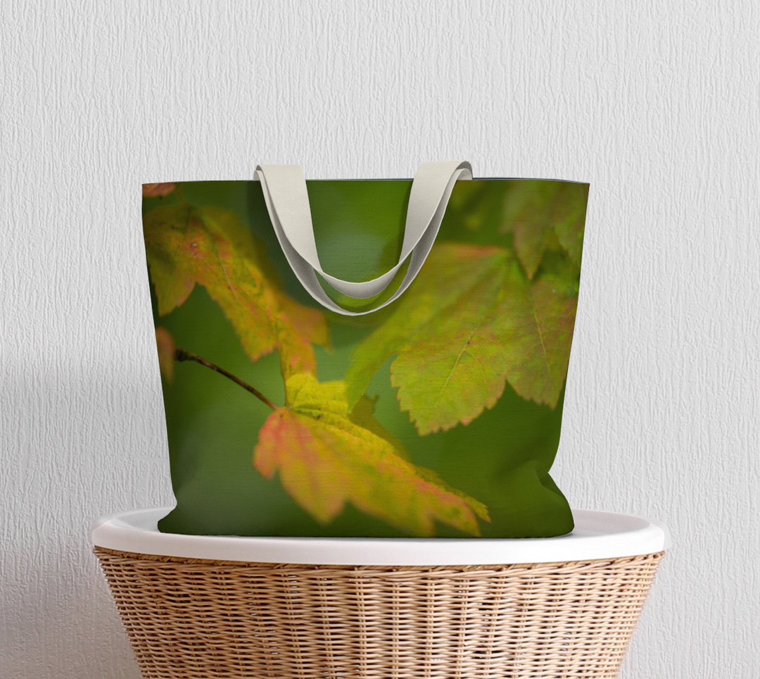 Maple leaf market tote with 1.5 inch wide cotton straps sitting on basket