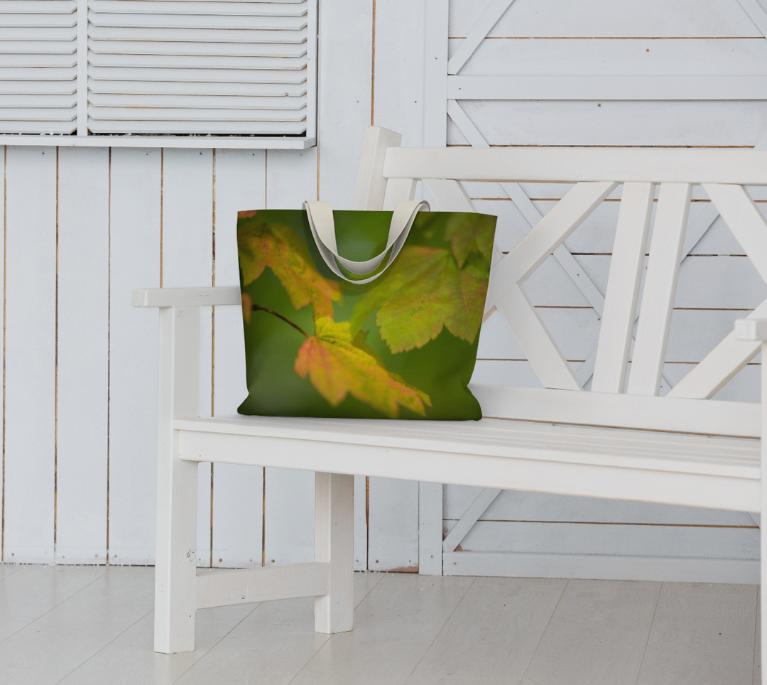 Maple leaf market tote with 1.5 inch wide cotton straps sitting on bench