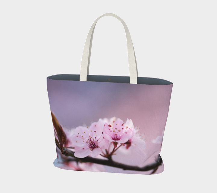 Cherry Blossom Market Tote features an image of two cherry blossoms with a lavender and pink background